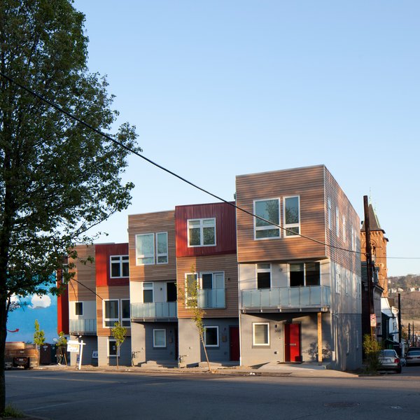 Embracing this modularity, we chose to articulate these distinct prefabricated “boxes” through the use of contrasting finish materials. The modular buildings were pushed, pulled, and stepped using the typography of the site to our advantage. While maximizing unit areas on the small site, the design solutions provided further individual definition to what could have otherwise been literal nondescript “vanilla boxes”. Photo 5 of Croghan's Edge Townhomes modern home