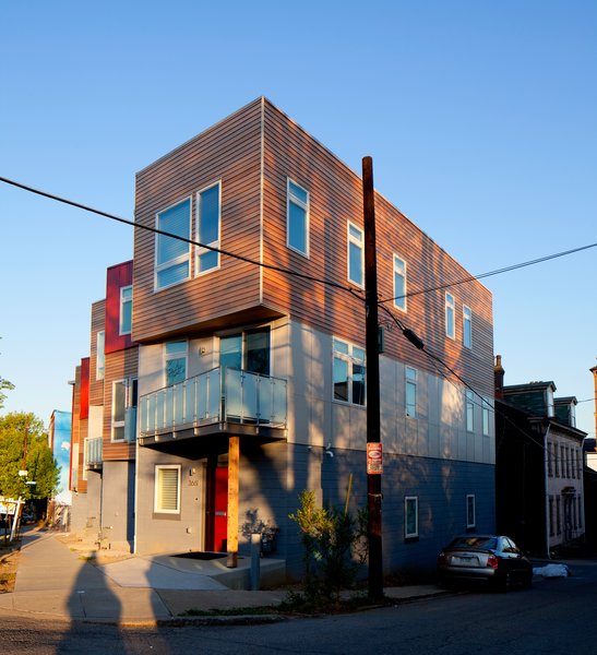 The Croghan’s Edge Townhouse project addressed a difficult infill challenge in Pittsburgh’s dense urban Lawrenceville neighborhood. The challenge was to accommodate four distinct for-sale residences on a small triangular site of only 3,300 square feet in an area that is surrounded by two streets and an alley. Additionally, the developer’s intent and desire was to use factory-built modular components for the upper stories. The solution was to develop a scheme that not only addressed the neighborhood row house scale, but also provided a contemporary interpretation of the neighborhood context. Our design turned the site problems into opportunities for a unique solution. Photo 4 of Croghan's Edge Townhomes modern home