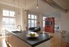 Punctuating the white palette and historic building details as pops of modern design and color are two freestanding volumes, clad in custom red panels and placed so as to define specific living spaces within the long, rectangular loft. These “cubes” separate public zones from private and create rooms without walls or doors, while appearing to float under the 12-foot-high ceilings. Photo 2 of Y Lofts modern home