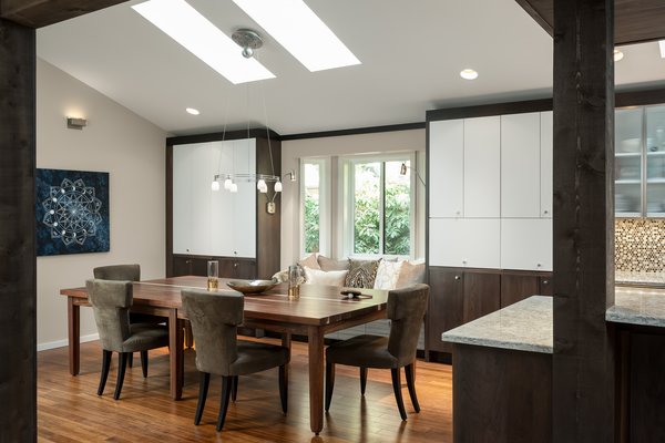 Our design was planned to "fit" a ping pong table, but it was the homeowners who found this awesome combination ping pong table/dining table which looks great and works very well in the space. The light fixture over the table moves up and out of way during play time. The angled window seat was part of the original architecture, but we added storage below, expanded the seat, and flanked the area with generous and attractive storage. Photo 5 of The Ping Pong Home modern home