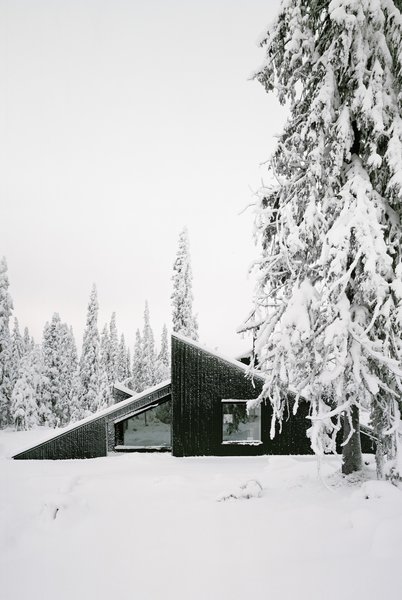 A Look at 10 Minimalist Scandinavian Cabins - Photo 4 of 10 - The concept of this Scandinavian getaway was simple: to create a cabin that's small and sparse, yet spatially rich. The 592-square-foot cabin, commissioned by a private client and completed in 2016, comprises a large living room, bedroom, ski room, and small annex with a utility room. It functions off the water and electricity grids.