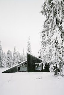 A Look at 10 Minimalist Scandinavian Cabins - Photo 4 of 10 - The concept of this Scandinavian getaway was simple: to create a cabin that's small and sparse, yet spatially rich. The 592-square-foot cabin, commissioned by a private client and completed in 2016, comprises a large living room, bedroom, ski room, and small annex with a utility room. It functions off the water and electricity grids.
