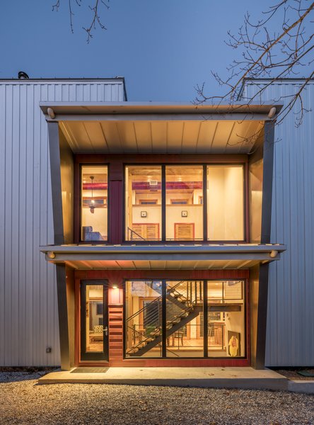 Elements such as solar design, triple pane Zola windows, energy efficient appliances, a rainwater catchment system that supplies all the water and healthier eco-friendly materials – repurposed bowling alley lanes for countertops and recycled wood used throughout – are just a few of the sustainable features incorporated into this innovative design approach. The overall goal was to keep the design footprint small, and the views grand. Covered with a metal panel system, it’s a rustic yet high tech cabin nestled in the woods for the 21st century. Photo 9 of Love Shack modern home