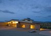 "We chose some pretty unique materials for the La Tierra Nueva, informed by Northern New Mexico’s traditional building materials, such as mud plastered, site cast adobe and corrugated metal in addition to colors and textures found on the site. The house incorporates zinc siding, selected for its color connection to the site. We used cladding for the walls, and corrugated roofing. The glass was meant to open the home up toe the environment. Finally, the rammed earth building technique had a strong connection to the site itself. " Graham Hogan, AIA, LEED of Studio GP LLC Photo 15 of La Tierra Nueva modern home
