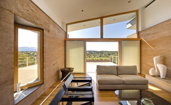 "As architects, we rarely have enough choices in terms of glass to specify the glazing itself as we design projects. Zola has great options, which allowed us to specify the glass itself based on the unique needs in different parts of the house. On the West-facing side of the home, we were able to specify and use Zola glass that has a higher shading coefficient. It was great to have this option. The Thermo Clad is crafted in beautiful wood that really worked well with the setting. It emphasizes the home’s “one with nature” theme.
The floor to ceiling windows certainly give a majestic feel to the home, especially in the night-time photographs. Explain to us why the homeowner wanted this completely open facade.
The homeowners love Sante Fe and wanted to bring the views into the house by blurring the connection between the interior and exterior as much as possible. You have to be very careful doing this: one must consider how the use of so much glass is balanced with energy efficiency of the house. Because of the performance of Zola windows we were really able to exploit this and have been able to create a number of large window walls, which really open the house to the outdoors." Graham Hogan, AIA, LEED of Studio GP LLC
http://www.zolawindows.com/thermoclad/ Photo 3 of La Tierra Nueva modern home