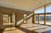 The home’s materials and colors were drawn specifically from the site to help it meld into the landscape. It is a custom rammed earth house. Rammed earth is an ancient process originating in the Middle East inspired by a desire to be one with nature. It is a style and building technique that is true to the region, the foundation of the adobe construction that is popular in Santa Fe and surrounding regions. The masonry of the project makes it unique: it was carefully crafted to maximize and adapt to the varying temperatures in the region, allowing for comfortable interior temperatures. Photo of La Tierra Nueva modern home