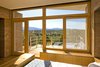 "The high desert sun in this part of the country makes for incredible sunrises and sunsets, but it is also a design challenge. We studied the sun patterns before putting a single stroke on the drawing board. You must find the sweet spot between combating extreme heat in the summer days, that is, controlling the heat gain in the summer, and also creating a comfortable interior during the cold nights. The roof has substantial overhangs sheltering the structure from the elements and shading the home’s glazing from the sun. The climate and geography of Santa Fe make it a challenging and exciting canvas to work with. We approached site selection through the lens of opportunity rather than challenge: we chose a location along a ridge to maximize access to the sun. The location also carefully tucks the home’s decks and outdoor living space out of the line of the winds, which can be very strong in Santa Fe." Graham Hogan, AIA, LEED of Studio GP LLC
Zola Thermo Clad Lift & Slide Door Photo 14 of La Tierra Nueva modern home