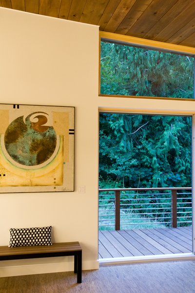 Modern home with kitchen. Daylight streams through the Zola Lift & Slide Door that leads seamlessly outside to the natural landscape. The home perfectly transitions to from indoor to outdoor with an airy, light serene feel throughout the home – with an active relationship to a variety of well-crafted outdoor space; gratuitous entry steps, generous utilitarian carport, sheltered semi-private dining patio, integrated screened porch, and an adventurous environment as well. Photo 7 of Cedar Haus