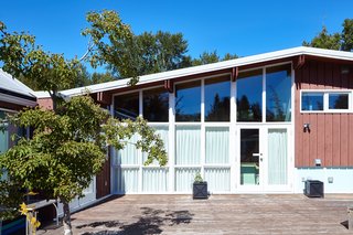 Styling a Rescued Mid-Century Gem - Photo 6 of 6 - Floor-to-ceiling windows on the home's south side flood the main floor with light. 