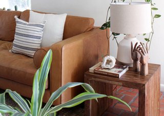 The warm tones of a cognac leather sofa ground a space with lots of color. 