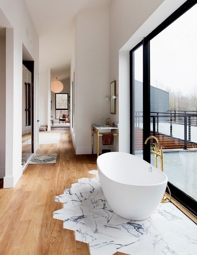 How to Use Modern Home Decor in Unexpected Ways - Photo 3 of 9 - It might look complicated, but Studio DB's Britt and Damian Zunino, the duo behind this stunning bathroom space, say transitioning tiles to wooden floorboards is surprisingly straightforward.