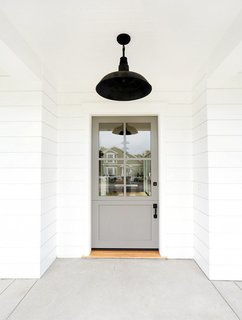 What's the Best Color to Paint Your Front Door? Your Guide to Finding The One - Photo 9 of 22 - If you feel most at home in neutral territory, you may want to consider going gray. Take this door for example: An earthy gray color sets a relaxing, inviting tone that makes pretty much anyone want to step inside.