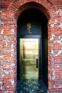 What's the Best Color to Paint Your Front Door? Your Guide to Finding The One - Photo 15 of 22 - This metallic gold door shines bright to welcome guests to L.A.'s Hotel Covell. Against a backdrop of more textural, aged elements like brick walls, it's a chic, smooth, glam touch.