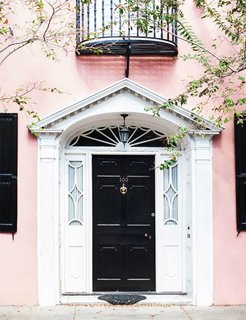 What's the Best Color to Paint Your Front Door? Your Guide to Finding The One - Photo 7 of 22 - Knock, knock. Who’s there? A fresh front door color combination. It doesn't get more classic that a jet-black front door, but in this case, the blush walls give the traditional shade a trendy new twist.