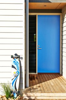 What's the Best Color to Paint Your Front Door? Your Guide to Finding The One - Photo 11 of 22 - When you have a clear favorite color, it's a no-brainer to paint your front door. And it's hard to beat the cool factor that comes from a vibrant blue front door like this one. The shade is a modern mid-blue that's not too light and not too dark. Best of all, it connects back to the accent colors in other favorite items like the owner's longboard.