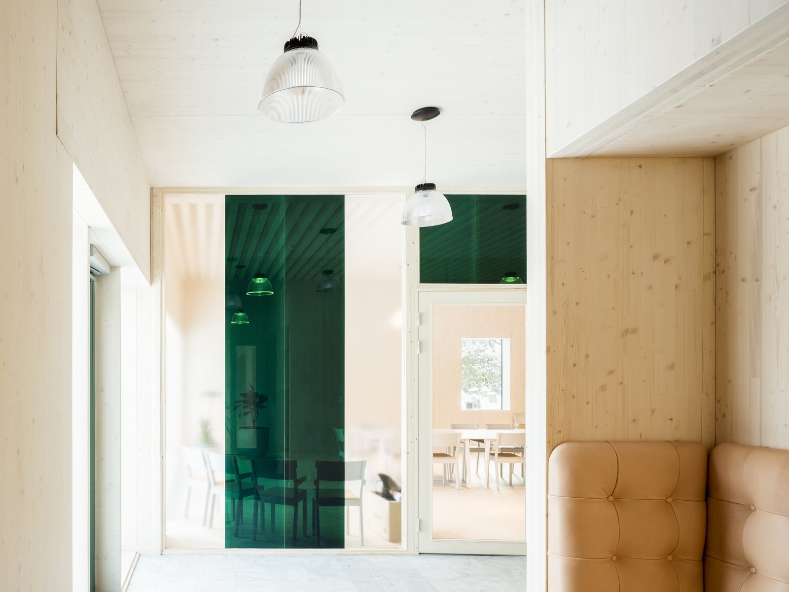 The interior design is characterized by restraint. Wood complements leather and concrete for a modern, natural-looking building that blend together with its lush surroundings.