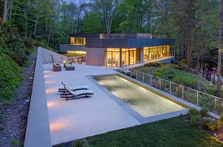 12 Modern Marvels in New England - Photo 12 of 12 - The Weston Residence nestles in a valley adjacent to the Saugatuck River. It’s a small house, but takes advantage of its beautiful site in a way that purposefully blurs the distinction between the built and natural environment.