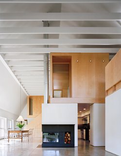 12 Modern Marvels in New England - Photo 9 of 12 - Simple and durable, yet elegant materials such as polished concrete, second-grade oak flooring, and maple plywood are used throughout. Interior and exterior connect visually through a wall of glass doors to the garden and fields beyond.