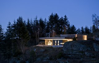 A Look at 10 Minimalist Scandinavian Cabins - Photo 3 of 10 - The pavilion concept of this cabin is emphasized by its large roof, which also serves as a shelter for rainy days.