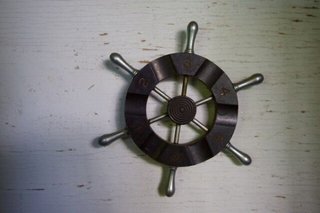 Hanalei Bay Villa – Contemporary Home on Hanalei Bay Offering Art & History - Photo 6 of 9 - Mini ship wheel mounted inside of bookshelf 