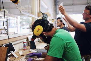 Craft & Vigor:
Inside Design at Grovemade - Photo 6 of 9 - Sean showing us the sanding process as Alex Boepple and Misbah Afshari do finish work.