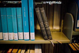 Sacred Space: an Exploration in Modern Bible Design - Photo 6 of 6 - Two Reader's Bible volumes rest at an angle on the shelf at the Mt. Angel Abbey Library.