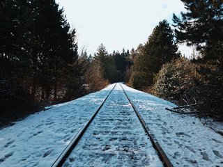 VSCO RAW/X and Topo Designs - Photo 7 of 9 - Icy foot tracks mark this snow-pelted section of railroad track.