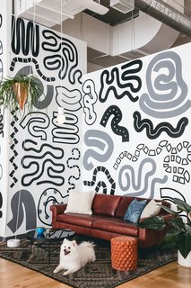 Organic painted patterns create a fun and inviting vibe in this open sitting space.