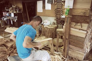 The Community-Run Cedar House by Airbnb and Go Hasegawa Welcomes Guests in Rural Japan - Photo 2 of 12 - From the foresters, to the woodcutters, to the carpenters, and finally to the host, the townspeople have been integral to the life of the Yoshino Cedar House. Here, a worker is seen splitting and preparing cedar planks for use.