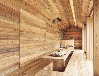 The Community-Run Cedar House by Airbnb and Go Hasegawa Welcomes Guests in Rural Japan - Photo 6 of 12 - The ground floor doubles as a collective living space where locals and guests can gather. This unique built-in dining table is recessed into the floor, giving the room and table a seamless and inviting effect.