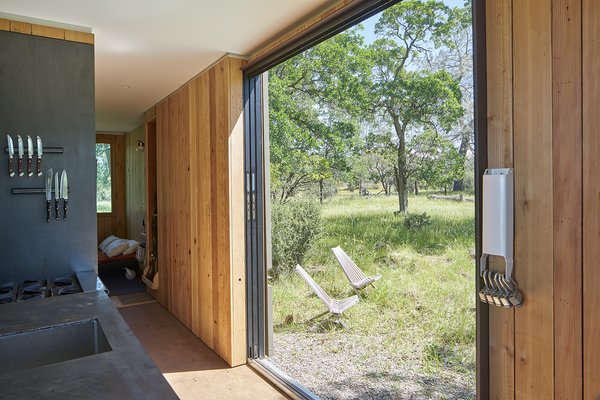 A conservation easement in favor of the Nature Conservancy prohibited permanent development so we customized two shipping containers off site, and then transported the new ‘cabin’ via truck to the property. Together with the client, we chose an ideal landing spot next to an old creek bed, with sunset views of Black Butte cinder cone. The cabin is completely off the grid and can be locked up tight when not in use. Photo 13 of Container Cabin modern home