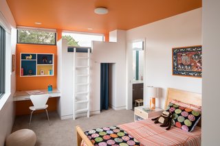 This second- floor children’s bedroom is made for fun: A jungle gym on the far wall includes a curtained-off play space, and kids can climb by ladder up to a little bed where friends can gather or sleep over. (It is removable, so the room can be made into a more grown-up space in future years.) Using the animal artwork over the bed as inspiration, Goff added a playful giraffe table lamp from Alex Marshall Studio, IKEA Odestrad bedding, and Oeuf Sparrow Nightstands from All Modern. 