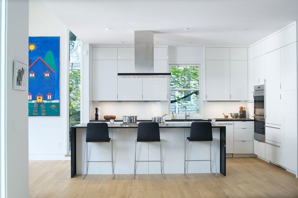 An open floor plan with uninterrupted views from the front to the back of the home provides a stark transformation from the original “boxy” floor plan. Designed to cater to university events as well as day-to-day routines of the home’s residents, Meade notes that the first floor was designed so that “only one room can close itself off in order to create visual and physical openess. If you are hosting events, you can have everyone in a single space, but still have them in different “spaces.” Photo 3 of Modern Victorian modern home