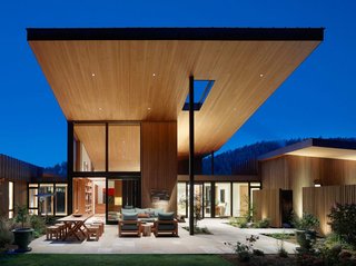 Naturally Modern - Photo 1 of 15 - RCR – Resting on eight acres, this 9,000-square-foot Montana house is actually a series of connected buildings surrounding an elevated courtyard. Built for a couple whose previous ranch property was designed by famed Argentinian architect Emilio Ambasz, the home was constructed around two central priorities. First came siting strategy, which takes advantage of a meadow that runs up against the base of a butte with old growth pine. Next came the creation of a space suitable for the clients’ world class art collection – a compound contextual enough to fit the surrounding area, strong enough to stand on its own merits, and flexible enough to let the art shine through. The interiors feature a reductive materials palette, with wood and plaster surfaces that add warmth without competing with the show-stopping pieces scattered throughout the home. Photos by Matthew Millman