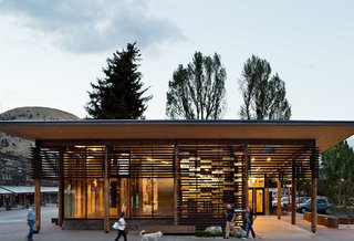 Naturally Modern - Photo 5 of 15 - HOME RANCH – Jackson Hole’s Home Ranch Welcome Center rests at the northern entrance to historic downtown, where it provides visitor information about opportunities for discovery in the town of Jackson and the surrounding National Parks. Program components are expressed individually, as an opaque concrete enclosure houses restroom facilities, and a gallery on the public corner is light-filled and transparent. Inspiration for the project was taken from the regional abundance of porches, which provide welcome, shelter, and entry for natives and tourists alike. Carney Logan Burke also worked with a local artist to create Jackson’s first publicly funded art project, Strands. The work is made of glass bricks representing bison and bear DNA, and those bricks are integrated into the building’s solar shade screens. The Home Ranch Welcome Center won three AIA Awards, including a 2014 Award of Excellence from the Wyoming Chapter. Photo by Paul Warchol.