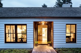 A house in Portland, Oregon, keeps its double-hung windows well-maintained with regular coats of dark, contrasting paint.
