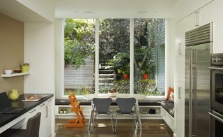 Form meets function with a banquette that boast built-in shoe storage and an easy-to-clean seat cushion.