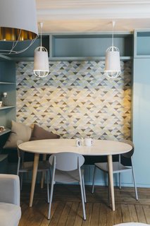 Chairs with clean lines in a signature hue add punch to small breakfast nook. 