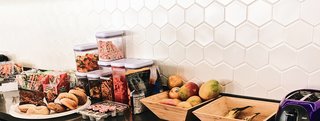 Certain pops of color throughout the space, and the honeycomb backsplash shown here, mimic the product. Nuanced touches such as these bring a smile to the face of those who are in the know.