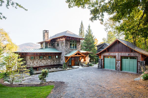 The couple with young children asked us to design a home that would utilize essentially the same footprint as the seasonal one story camp that has occupied the property since the 1950’s. The owner’s admiration for Japanese Architecture and a simple open plan guided the design team to create a blend of western architectural influences with regional influences of the northeast. Photo 2 of East Meets West in the Adirondacks modern home