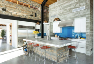 A Yurt-Inspired Vacation Home on the High Desert Plains of Colorado - Photo 6 of 8 - As the saying goes, the kitchen is always where guests gather—but this kitchen also happens to connect the living room and entry to a large outdoor patio with views of the lake. Philips dome pendants hang above a sizable marble island encircled by Bertoia counter stools by Knoll.