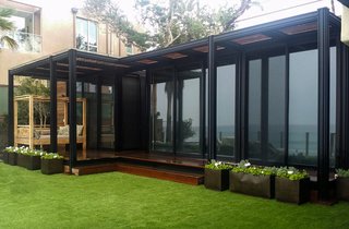 This prefab on the beach is a surfer's dream come true. Complete with a bronze anodized frame, 10-foot ceilings, and an outdoor shower, this oceanfront home in Malibu takes full advantage of its idyllic location. 