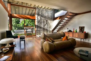 Escape to the Jungle in One of These Modern Forested Retreats - Photo 6 of 10 - Set in a 1970s Brutalism residence designed by Brazilian architect Wladimir Alves de Souzain, and located at the heart of Santa Teresa in Rio, Chez Georges, is a nine-bedroom hillside house with soaring ceilings and a music studio that overlooks the Brazilian rainforest.
