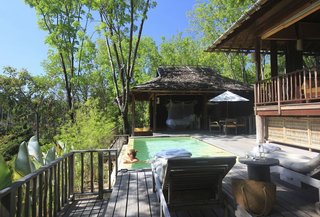 Escape to the Jungle in One of These Modern Forested Retreats - Photo 7 of 10 - Embraced by the jungles of Thailand’s Koh Yao Noi Island, the villas at Six Senses Yao Noi have wooden poster beds, sofas upholstered in sunny yellow and orange, commodious bathrooms with a sunken bathtub, indoor and outdoor showers, a spacious infinity pool, and an outdoor pavilion. 