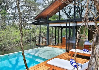 Escape to the Jungle in One of These Modern Forested Retreats - Photo 9 of 10 - Situated in a former agricultural site that's now home to a wetland forest, Kalundewa Retreat near the city of Dambulla, marries clean, modern lines with rustic teak and brick. 