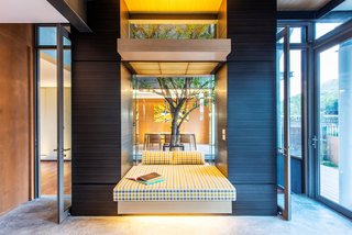 10 Homes With Large, Well-Ventilated Courtyards - Photo 9 of 9 - Inspired by the communal terrace courtyards of traditional multi-generational Thai homes, Thai architectural practice TA-CHA Design positioned a courtyard with a large tree in the center of the house to encourage circulation and increase interaction between household members. 