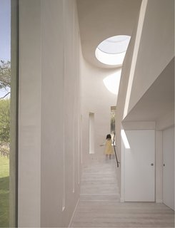 10 Light-Filled Homes With Interesting Skylights - Photo 1 of 10 - This beach house vacation rental in Cornwall designed by London architect Alex Michaelis has multiple skylights, including a double-height slot next to a winding staircase that brings in sunlight during the day and frames the starlit sky at night.