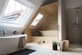 10 Light-Filled Homes With Interesting Skylights - Photo 7 of 10 - This converted attic in a turn-of-the-century building in Berlin’s Charlottenburg neighborhood has a large skylight on the side-slope of the roof, which allows one to look up at the sky while having a relaxing soak.