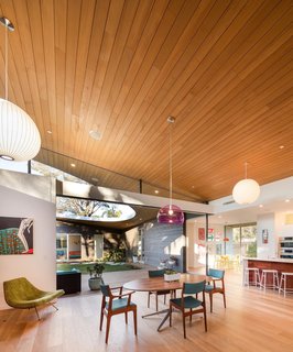 10 Light-Filled Homes With Interesting Skylights - Photo 10 of 10 - A large glassless opening on the sloping curved shed roof of this Californian home opens the courtyard to the sky and the elements, while giving the surrounding living areas an almost outdoor, park-like feel. 