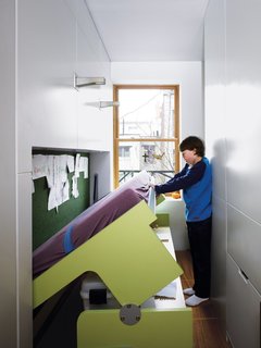 10 Homes With Clever Storage Solutions - Photo 3 of 10 - Space-savers in this 640-square-foot walk-up apartment in Manhattan's East Village include a dining table that disappears into a vertical space and a child’s bedroom study desk that transforms into a bed.